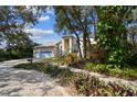 Landscaped front yard of a beautiful home with shade trees at 1001 Bayvista Dr, Tarpon Springs, FL 34689