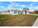 Charming light blue home featuring a well-manicured lawn and a two-car garage at 11248 Andy Dr, Riverview, FL 33569