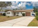 Charming single-story home with a well-manicured front yard and a brick and siding exterior at 121 Shirley Dr, Largo, FL 33770