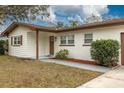 Charming single-story home with a well-manicured front yard and a brick and siding exterior at 121 Shirley Dr, Largo, FL 33770