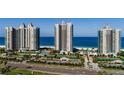 Aerial view of beachfront condos, lush landscaping, pools and recreational courts at 1540 Gulf Blvd # Ph7, Clearwater Beach, FL 33767