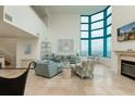 Bright living room with large windows and tile flooring at 1540 Gulf Blvd # Ph7, Clearwater Beach, FL 33767