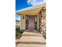 Inviting front entrance with a detailed door and stone accents, creating a warm welcome at 185 New England Ave # 33, Palm Harbor, FL 34684