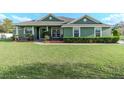 Beautiful single-story home with lush landscaping and a well-kept lawn at 3206 Duchess Ct, Plant City, FL 33565