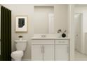 Cozy bathroom featuring a toilet, vanity with sink, and white cabinets with modern hardware at 12718 Crystal Jade Way, Parrish, FL 34219