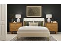 Comfortable bedroom showcasing a bed with nightstands, lamps, decorative pillows, and stylish wall art at 12718 Crystal Jade Way, Parrish, FL 34219