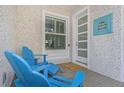 Cozy front porch with comfortable blue chairs, offering a relaxing outdoor space for residents at 230 Tucker St, Safety Harbor, FL 34695