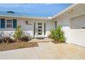 Inviting front entrance with a modern white door and clean, well-maintained landscaping at 2821 Coral Way, Punta Gorda, FL 33950