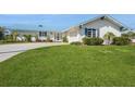 Lovely single-story home with manicured green lawn and a stylish light-blue metal roof at 2821 Coral Way, Punta Gorda, FL 33950