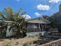 Quaint one-story house with a covered porch and tropical foliage adding charm at 3201 N 15Th St, Tampa, FL 33605