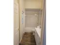 Bright bathroom with a shower-tub combo, single sink vanity, and wood-look flooring at 3801 Bramblewood Blvd, Land O Lakes, FL 34639