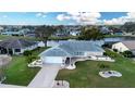 Aerial view of a lovely home with a well-kept lawn, landscaping, and water view at 2016 E View Dr, Sun City Center, FL 33573