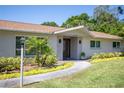 Charming home featuring a covered entrance, updated facade, and colorful landscaping at 2391 66Th S Ter, St Petersburg, FL 33712