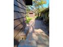 Lush backyard featuring a brick-paved patio, verdant grass, and a charming storage shed at 3010 County Road 31, Clearwater, FL 33759