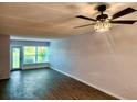 Bright living room featuring plank floors, a ceiling fan and sliding glass doors at 821 Deleon Ct # 108, Dunedin, FL 34698