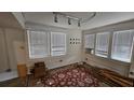 Empty living room with window blinds, carpet, and exposed beams at 1414 7Th S St, St Petersburg, FL 33701