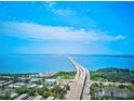 Aerial view showing home's location near a bridge and body of water at 3087, 3075 Cherry Ln, Clearwater, FL 33759