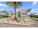 Luxury waterfront home with modern design, circular driveway & lush landscaping at 42 Midway Is, Clearwater, FL 33767