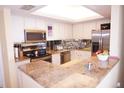 Spacious kitchen with granite countertops and stainless steel appliances at 4900 Brittany S Dr # 1303, St Petersburg, FL 33715