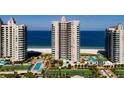 Aerial view of beachfront condo building with pool and tennis courts at 1540 Gulf Blvd # 806, Clearwater, FL 33767