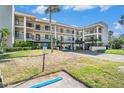 Two-story condo building with parking and landscaping at 8210 Aquila St # 223, Port Richey, FL 34668