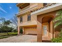 Two-car garage with paver driveway and gated entry at 1500 Ember Ln, Tarpon Springs, FL 34689