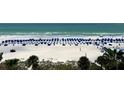 Expansive beach view with beach chairs, volleyball net and ocean at 5500 Gulf Blvd # 7211, St Pete Beach, FL 33706