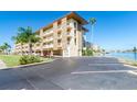 Exterior view of condo building showcasing parking and waterfront access at 105 Island Way # 121, Clearwater Beach, FL 33767