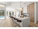 Modern kitchen with white quartz island and light wood cabinets at 6616 Hunter Combe Xing, University Park, FL 34201