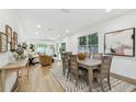 Bright dining room with light wood table and chairs, hardwood floors at 5334 37Th N St, St Petersburg, FL 33714