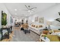 Open living room with light colored sofa and armchairs, hardwood floors at 5334 37Th N St, St Petersburg, FL 33714