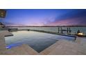 Modern waterfront pool with spa and fire pit at 266 8Th N Ave, Tierra Verde, FL 33715