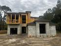 Two-story house under construction, featuring a modern design and a large two-car garage at 8418 Fussell Dr, Wesley Chapel, FL 33545