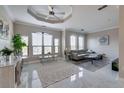 Spacious living room with marble floors, large windows, and comfortable seating at 2717 Via Cipriani # 631B, Clearwater, FL 33764