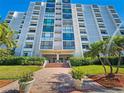 Building exterior showcasing the Yacht House at 851 Bayway with landscaping at 851 Bayway Blvd # 205, Clearwater Beach, FL 33767