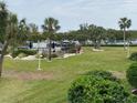 Community pool, patio area, lush landscaping, and waterfront views at 1375 Pinellas Bayway S # 29, Tierra Verde, FL 33715