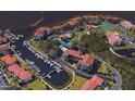 Aerial view of waterfront property with a marina, mature landscaping, and community pool at 1806 Mariner Dr # 214, Tarpon Springs, FL 34689