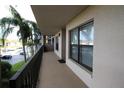 Balcony exterior view with palm trees and waterfront view at 1806 Mariner Dr # 214, Tarpon Springs, FL 34689