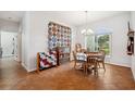 Bright dining room with wood table and large quilt at 3822 Salida Delsol Dr, Sun City Center, FL 33573