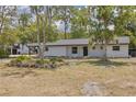 Newly remodeled home with a modern facade and landscaping at 7414 Van Dyke Rd, Odessa, FL 33556