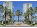 Grand entrance to Grande complex showing lush landscaping and building exteriors at 1180 Gulf Blvd # 2204, Clearwater Beach, FL 33767