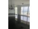 Open living space with black tile flooring and access to a balcony boasting ocean views at 1180 Gulf Blvd # 2204, Clearwater Beach, FL 33767