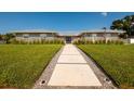 Charming single-story home with concrete walkway, stone accents, and landscaped front yard at 3931 38Th S Way, St Petersburg, FL 33711