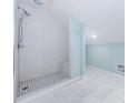 Step into a newly renovated bathroom with a shower featuring white subway tile at 49 W Boyer St, Tarpon Springs, FL 34689