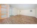 Bright bedroom featuring wood floors, a closet, and a frosted glass door at 49 W Boyer St, Tarpon Springs, FL 34689