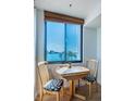 Small dining area with table and chairs near a window at 6268 Palma Del Mar S Blvd # 406, St Petersburg, FL 33715