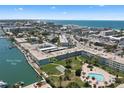 An aerial view shows the condo community near Boca Ciega Bay and the Gulf of Mexico at 6201 2Nd E St # 73, St Pete Beach, FL 33706