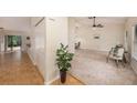 Bright foyer with a combination of carpeted and hardwood flooring leading to the main living spaces at 3482 Rolling Trl, Palm Harbor, FL 34684