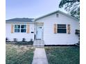 Updated white house with light blue door and landscaped yard at 811 40Th S Ave, St Petersburg, FL 33705