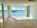 Bright living room featuring wall-to-wall windows with water views at 100 Pierce St # 703, Clearwater, FL 33756